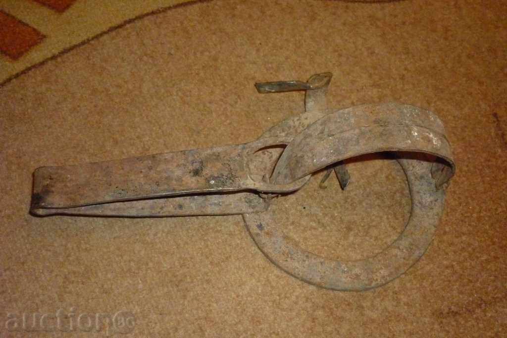 An antique hand forged trap An antique hand forged trap