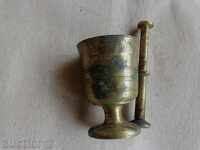 An old bronze mortar, mortar, hammer