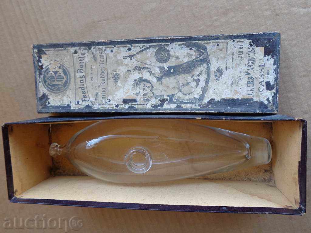 An old baby bottle, a bottle, a teat from the early twentieth century