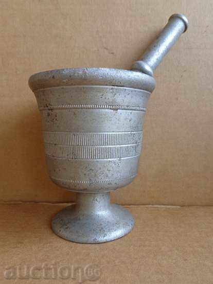 Old white metal mortar, pestle, mortar