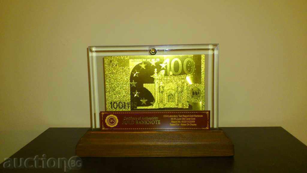 Auction 100euro golden banknote in a glass stand and solid wood Auction 100euro golden banknote in a glass stand and solid wood