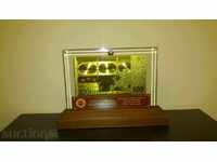 100 Euro gold banknote in a glass stand and solid wood