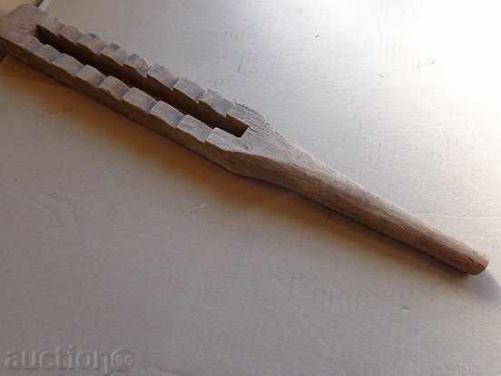 An old wooden beater, a wooden stick, a wooden stick