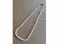 An old pearl necklace, a necklace, a necklace, a pearl
