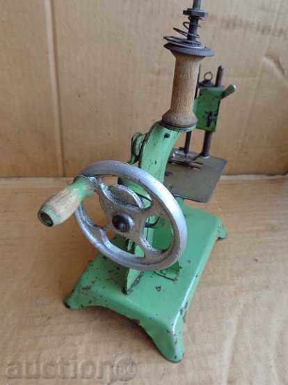 Delivery of A small sewing machine, a toy tin toy Delivery of A small sewing machine, a toy tin toy