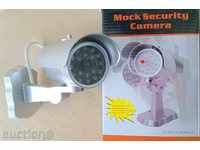 Fake video camera with motion sensor, motor and light sensor