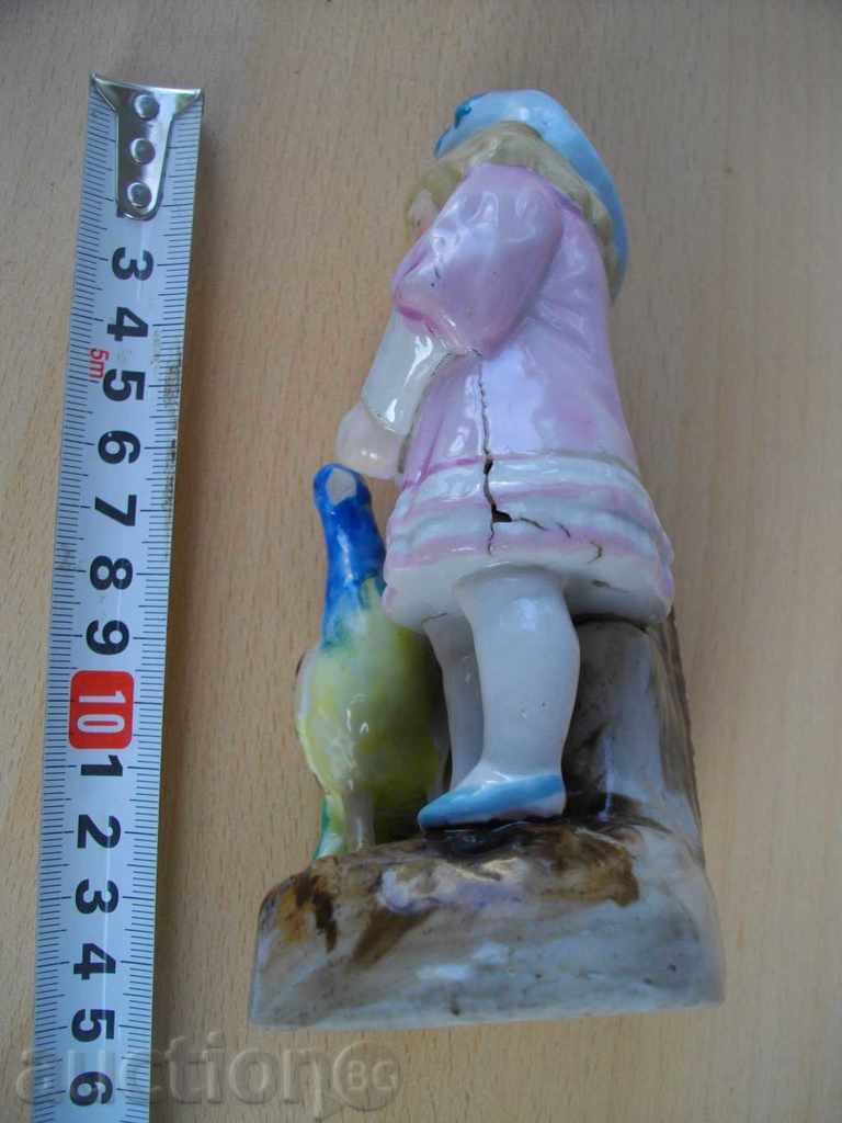 Delivery of Statuette "Child eating peacock" porcelain old for match Delivery of Statuette "Child eating peacock" porcelain old for match