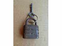 An old padlock with a key, a coffer, a latch, a lock, a catan