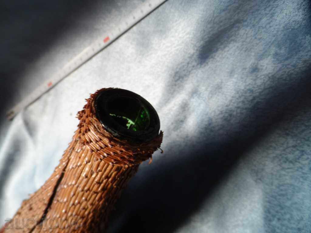 Auction an old glass bottle decorated with the bark of a coniferous tree Auction an old glass bottle decorated with the bark of a coniferous tree