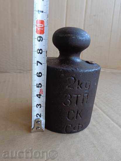 Old weighing scale, exaggeration, kilogram control weight Old weighing scale, exaggeration, kilogram control weight