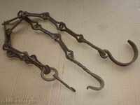 Old forged chain with hook, hearth for hearth