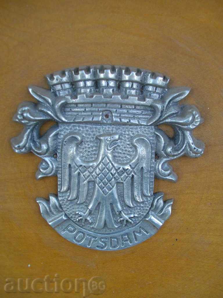 Auction The wooden plate with metallic "POTSDAM" Auction The wooden plate with metallic "POTSDAM"