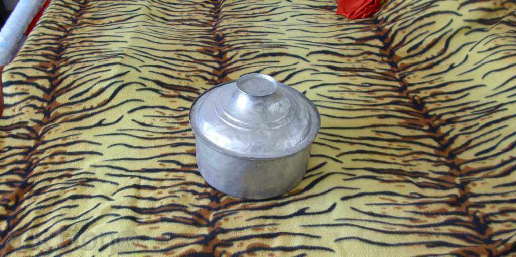 A large copper vessel/pot/ with a lid