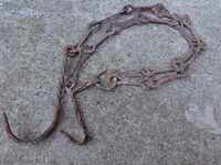 Old forged chain with hook, hearth for hearth