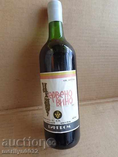 A bottle of red wine harvested by a juvenile UNPAIDED elixir