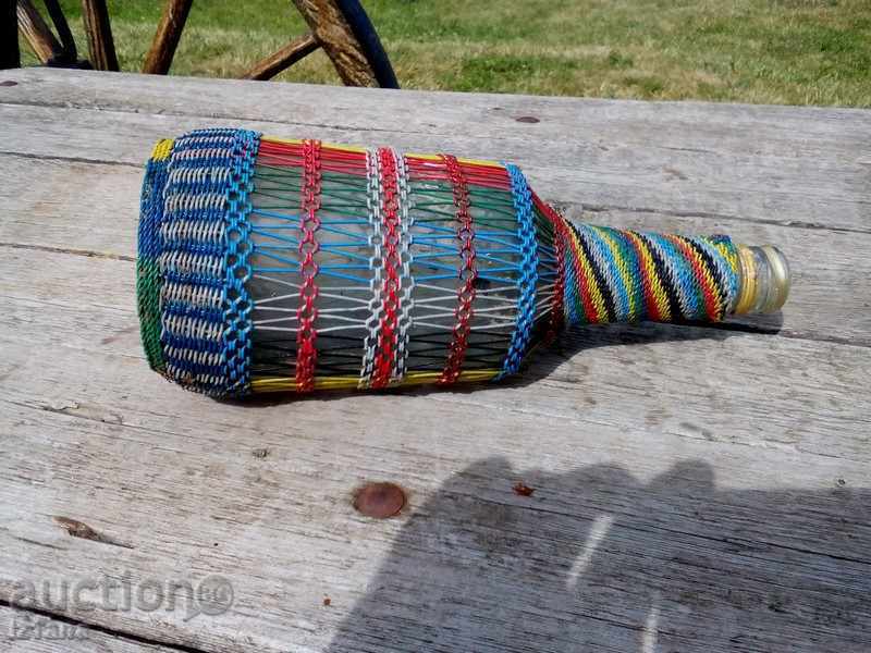 Auction  An old knit bottle, a bottle
