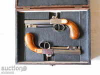 A pair of pre-loaded pistols, capsule, damask pattern with daggers