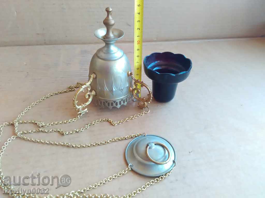Auction An old home-made bronze candela with a glass cup Auction An old home-made bronze candela with a glass cup