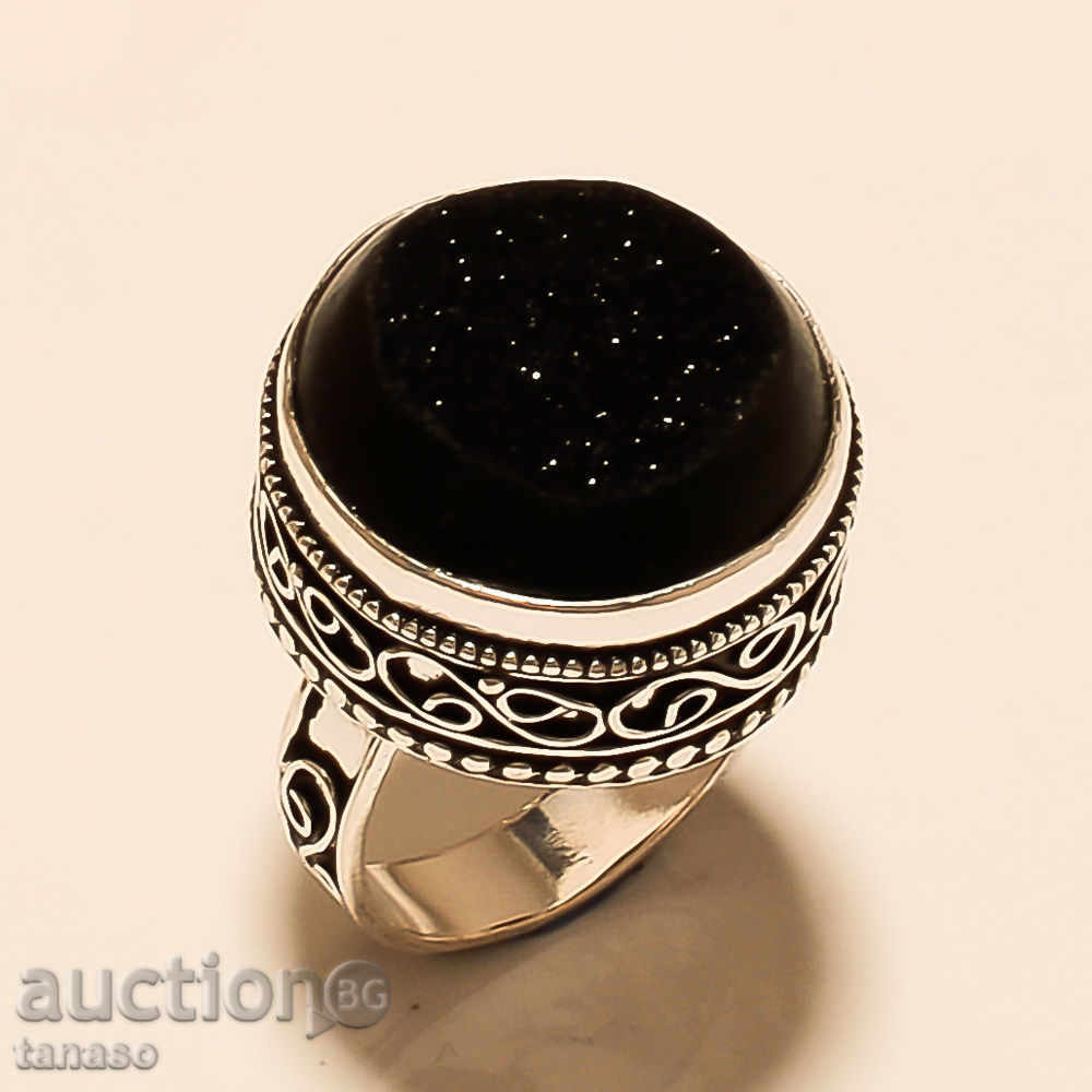 An art ring, massive silver plated with natural grandeur