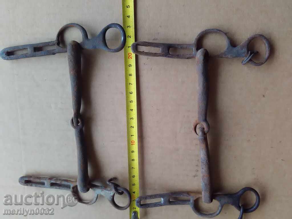 Auction  Old forged reins, a bent iron brace, a harness