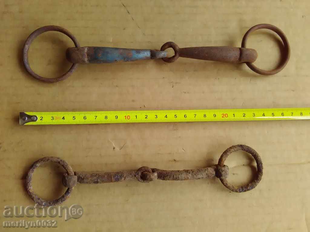 Auction  Old forged reins, a bent iron brace, a harness