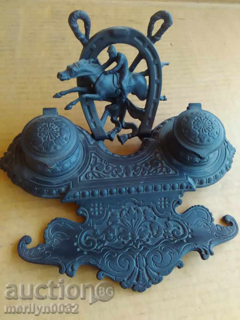 An old ink cartridge with a figure, a statuette, a figurine