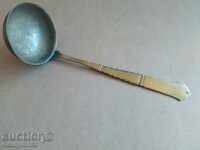 Old brass ladle with markings spoon