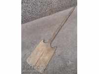 An old wooden shovel, a blade, a wood-burning wood