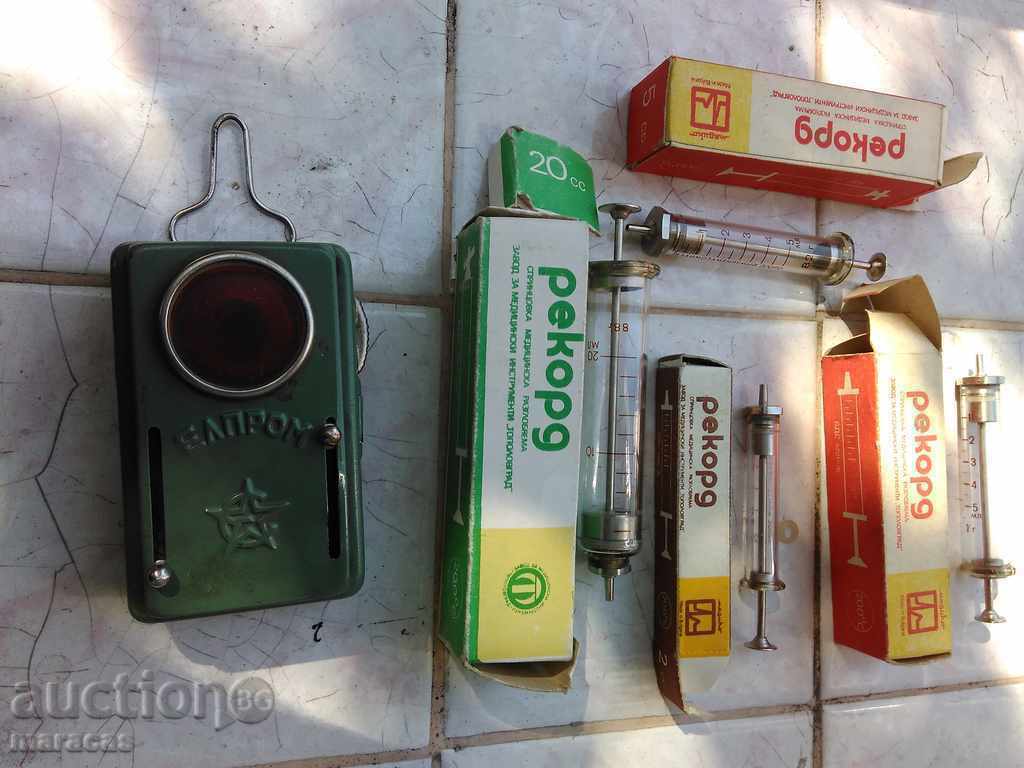 Unused glass syringes and railwayman's flashlight bulg