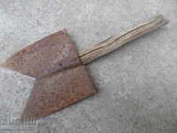 An old straight shovel with a gouged iron tool
