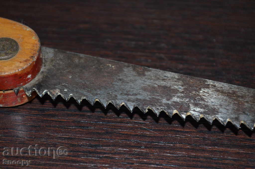 Delivery of Old steel saw with a wooden handle Delivery of Old steel saw with a wooden handle