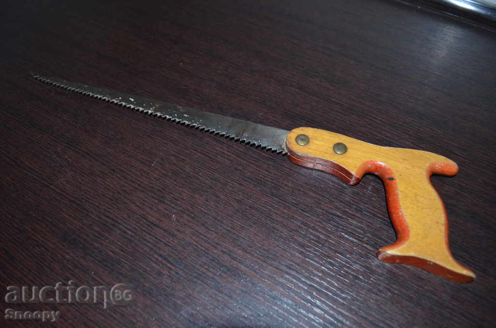 Old steel saw with a wooden handle Old steel saw with a wooden handle