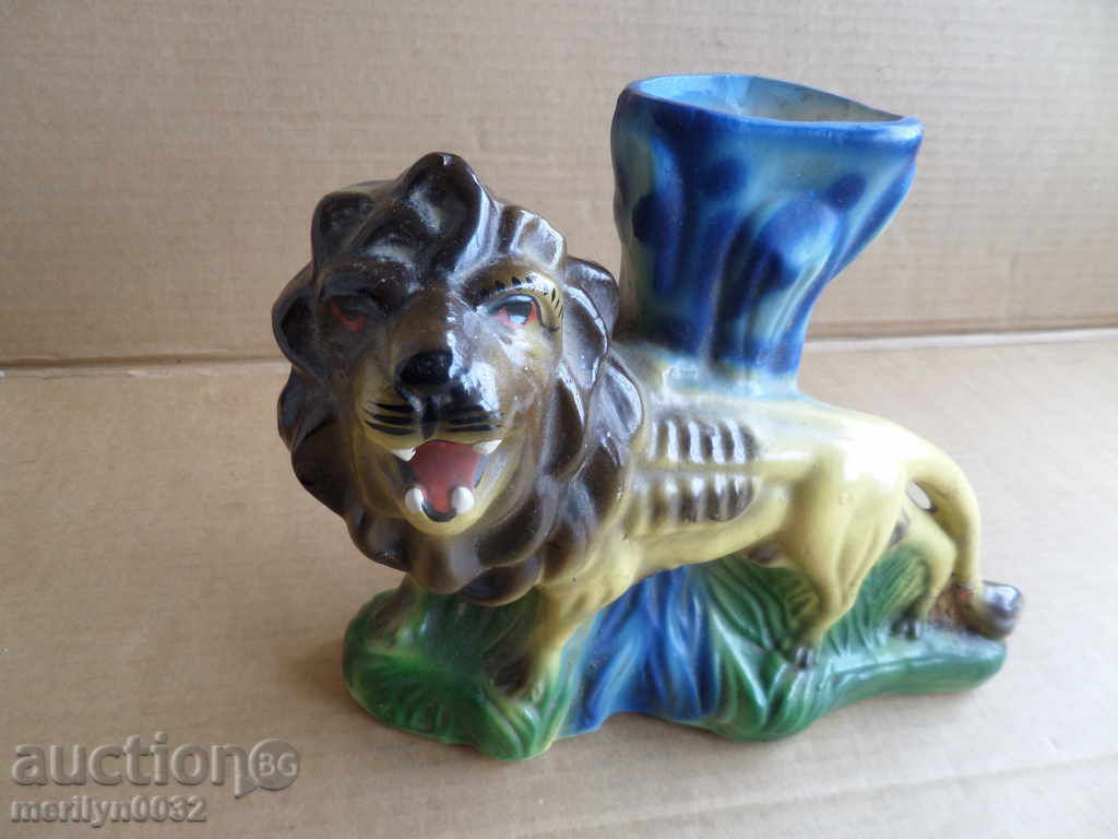 An old vase of ceramics with a lion figure