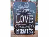 Metal sign lettering message Great love makes miracles