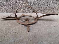 An old hand forged trap with wrought iron spikes