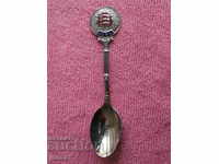 An old English silver soup spoon with enamel