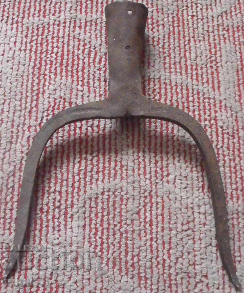 an old-wrought iron agricultural instrument