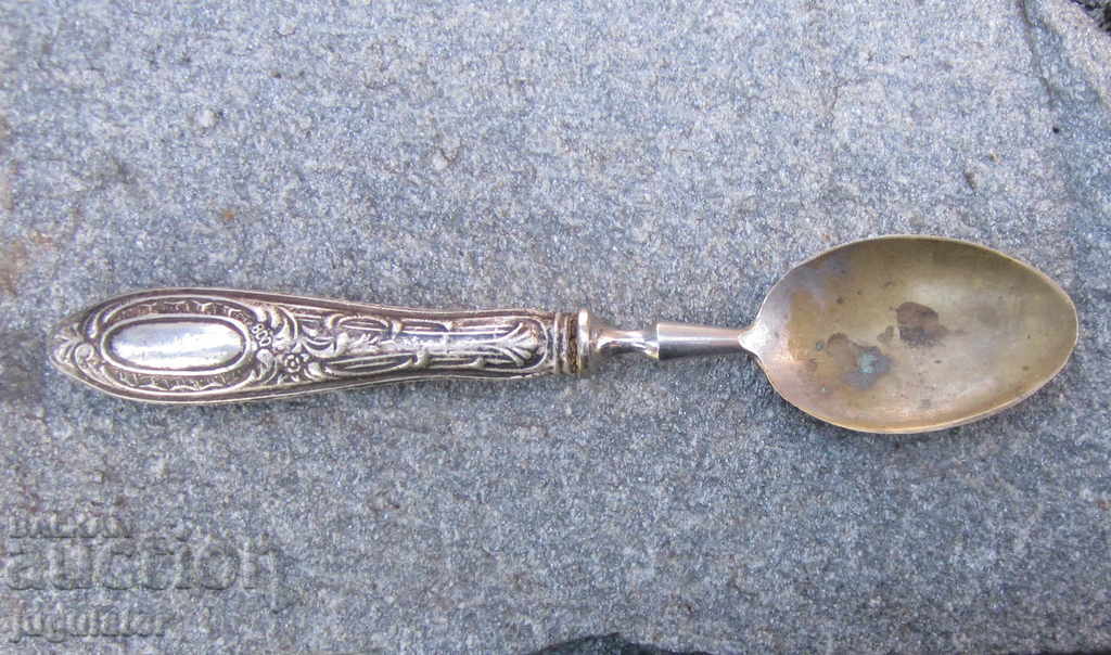 an old German spoon for serving with a silver handle