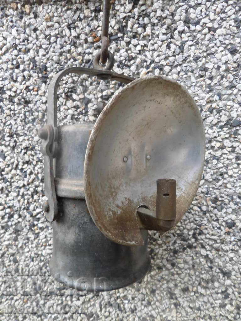 An old carbide mining lamp, a flashlight projector