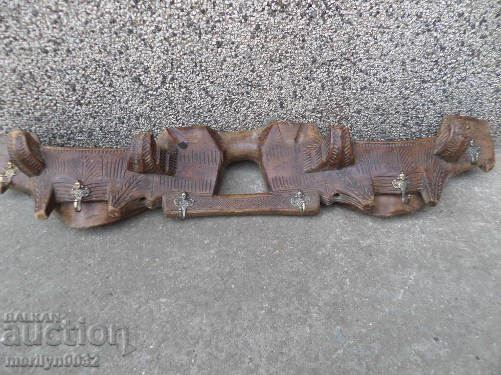 Old antique hanger with a woodcarving primitive