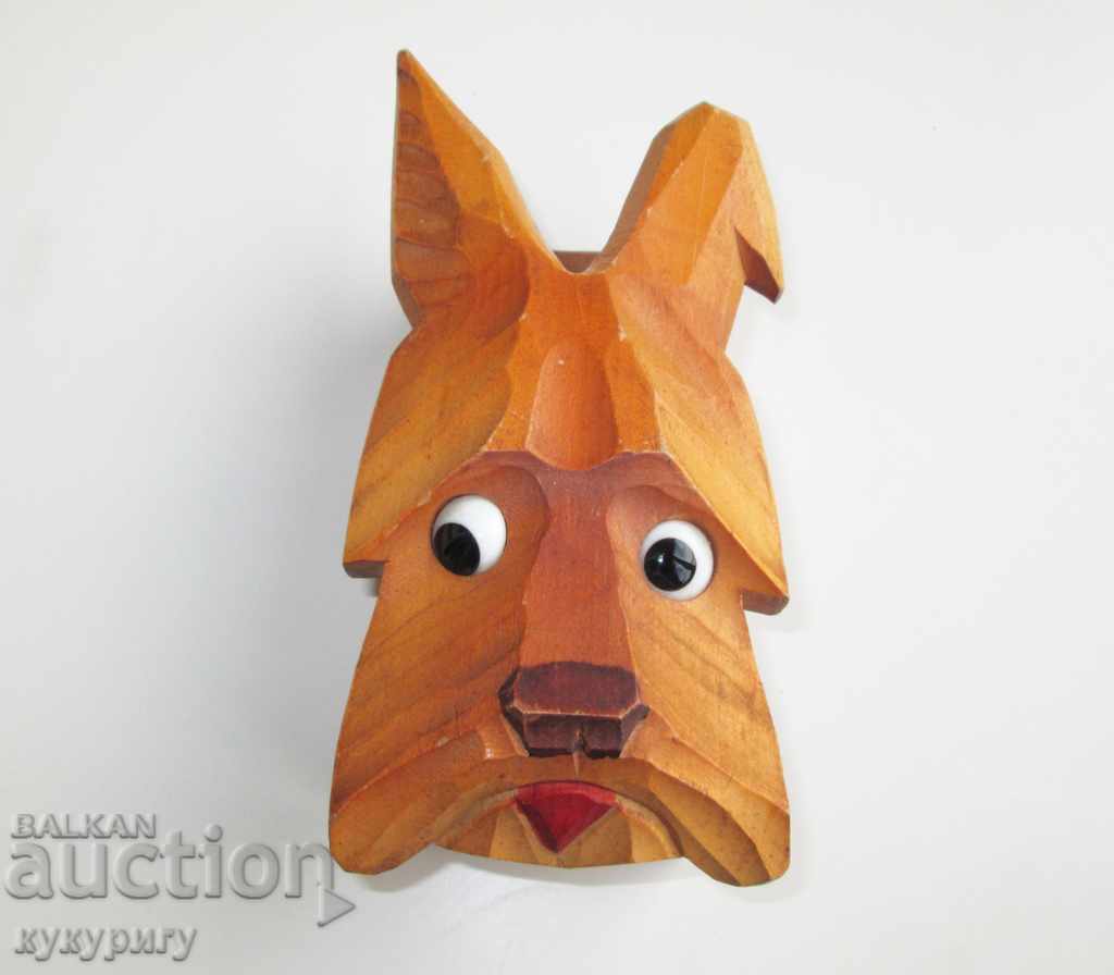 An old wooden carving dog with a glass eye wall mount