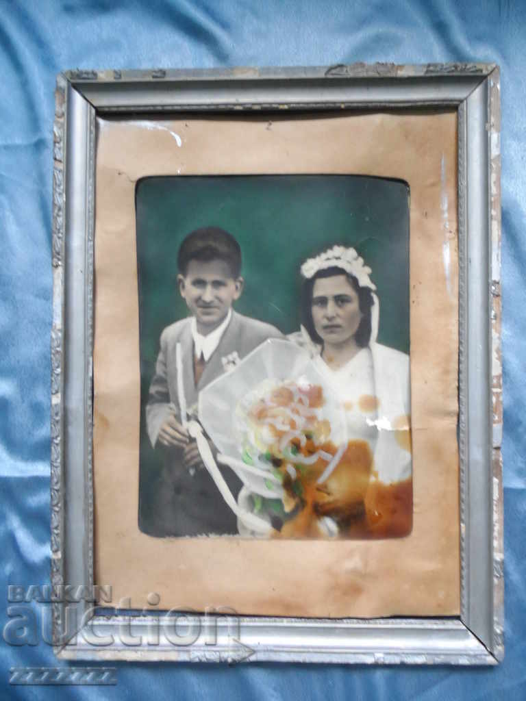 Large old colored cardboard photo in a frame