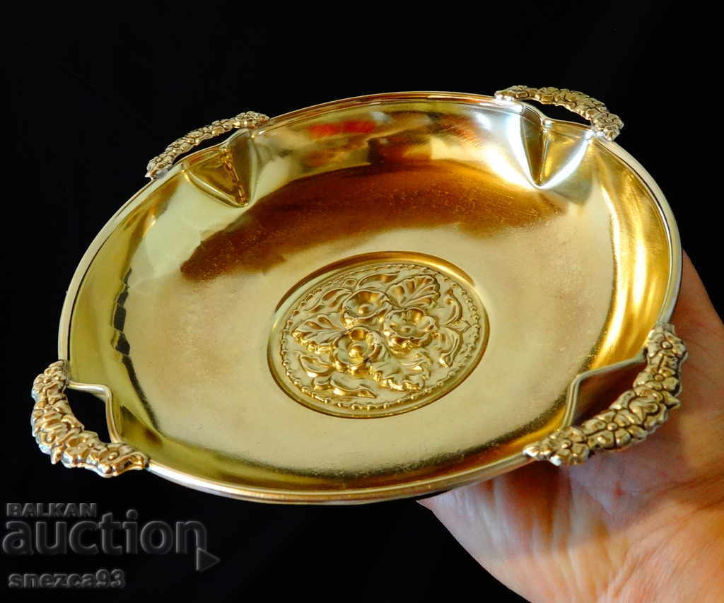 Brass fruit bowl with embossed flowers.