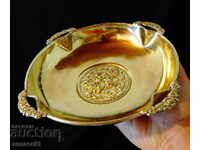 Brass fruit bowl with embossed flowers.