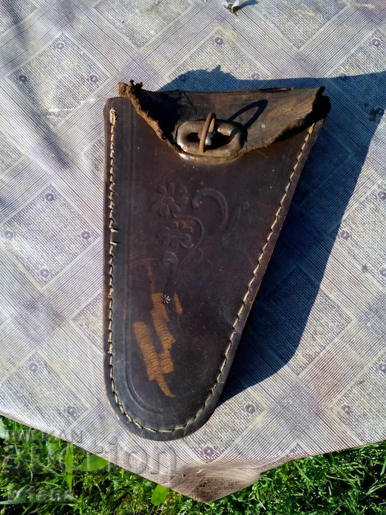 An old leather bag for a bicycle, a bicycle