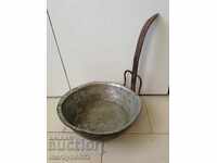 An old copper pan, a baker, a tray, a copper pot, a household pot