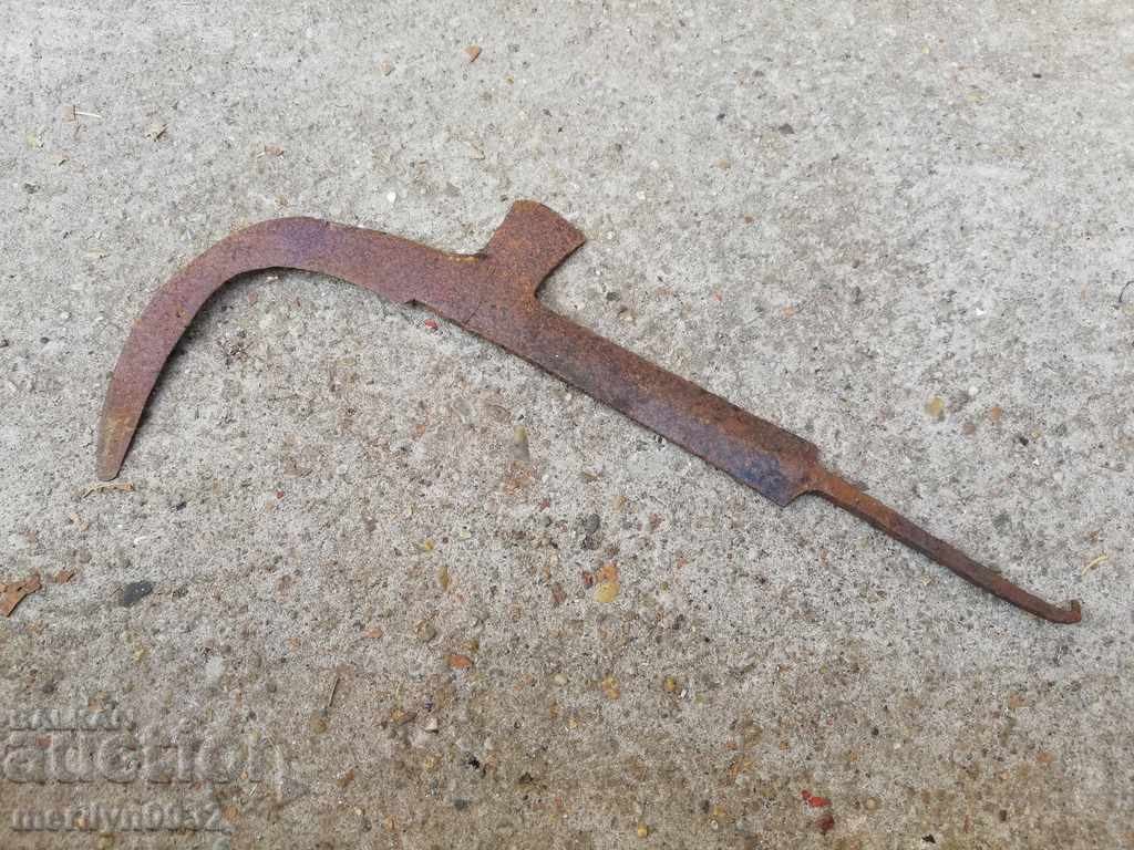 Old hand-forged scythe, wrought iron blade