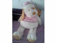 a big plush toy - a yellow dog with a pink blouse