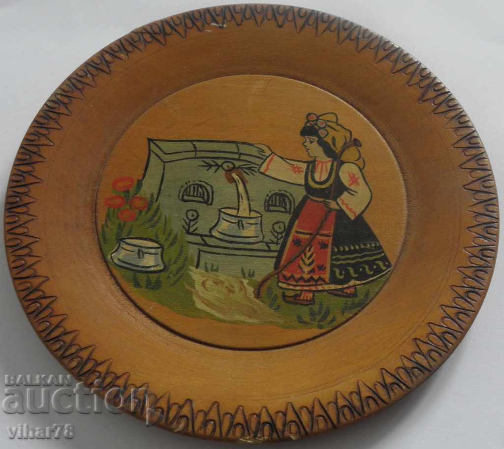 a small old wooden wall plate