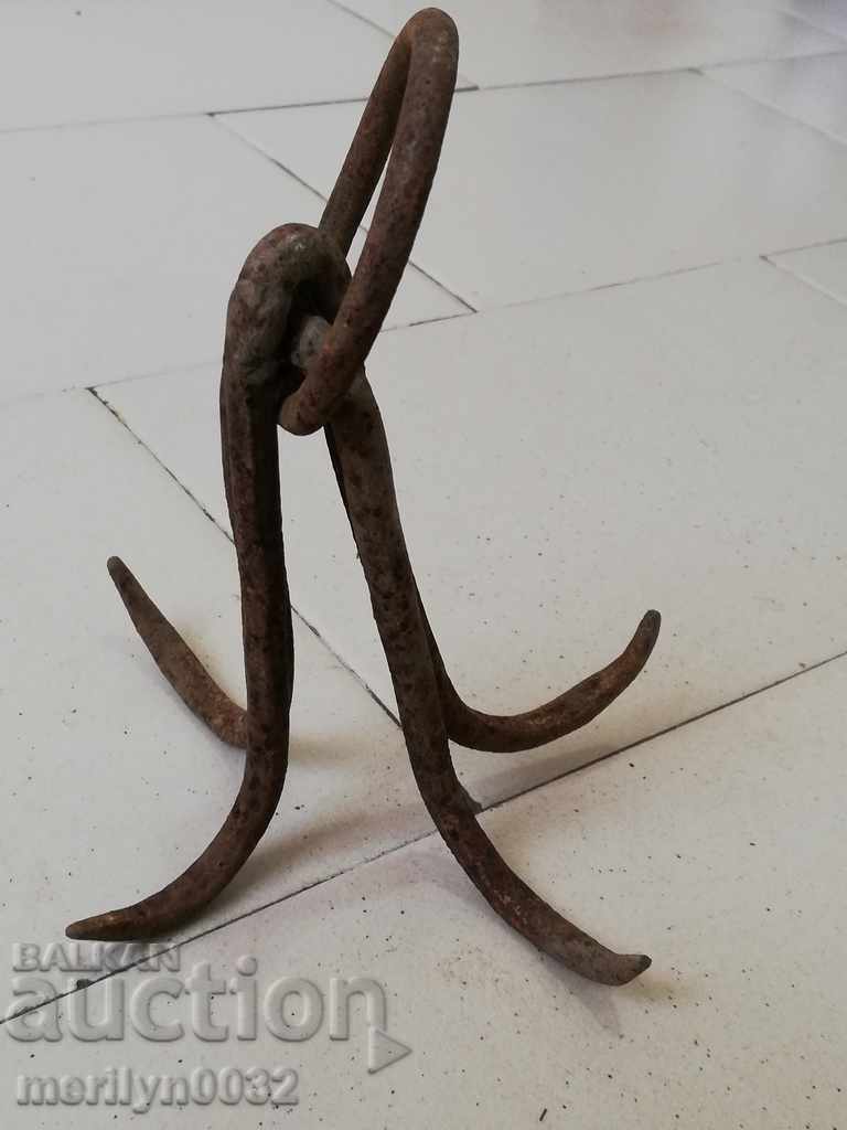 An old forged scraping hook, a quadruped neck